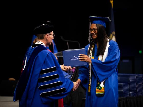 Photo of President Capilouto shaking a student's hand at Commencement