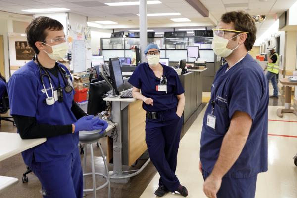 Nurse Jacob Heil, Pharmacist Regan Baum, center, and Dr. Joel Hamm,  collaborate in the Emergency department at UK which has  plenty of space for patients of all kinds  on March 23, 2020.