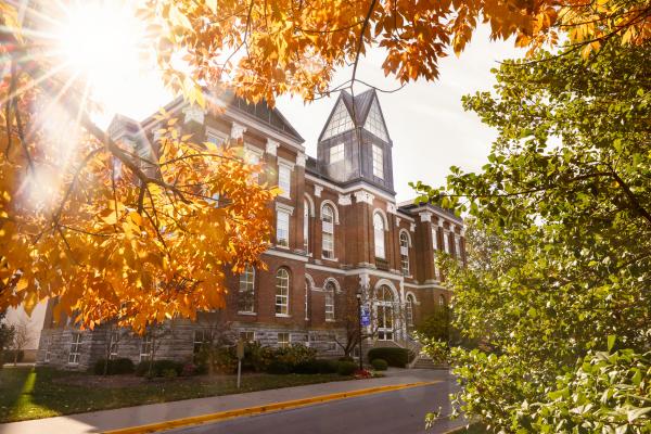 Main Building with fall leaves in the foreground. 