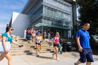 UK students walking on the stairs in front of the Chemistry-Physics Building.