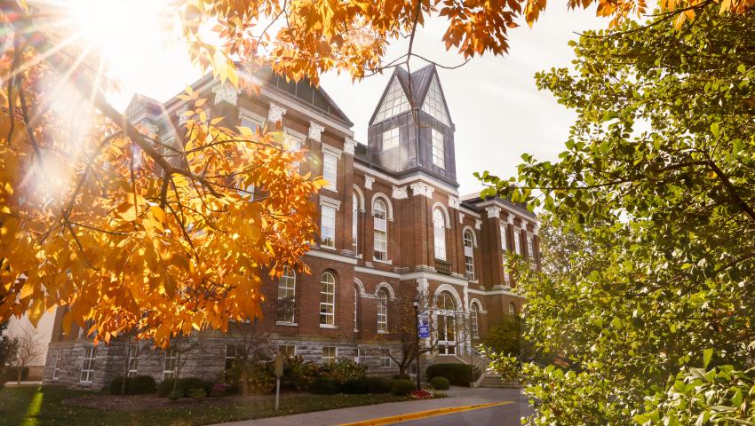 Main Building with fall leaves in the foreground. 