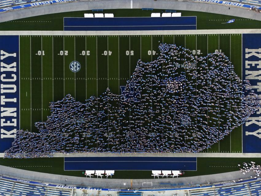 This is a photo from Big Blue U of students on the Kroger Field in the shape of Kentucky.