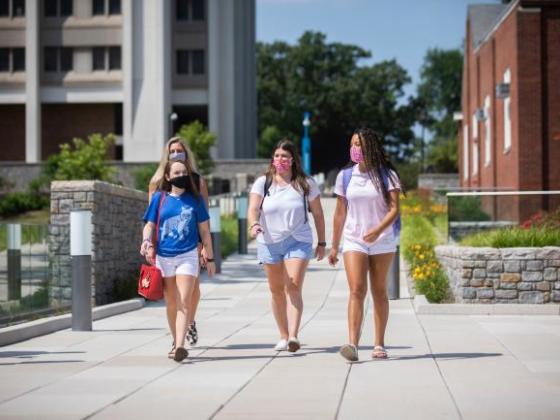 A group of female students walk into the Gatton Student Center