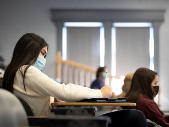 student taking notes in class