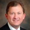 professional headshot of man in suit